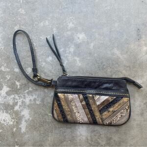 The Sak black and metallic gold wristlet